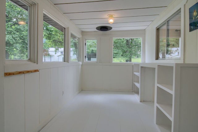 unfurnished sunroom with plenty of natural light and wood ceiling