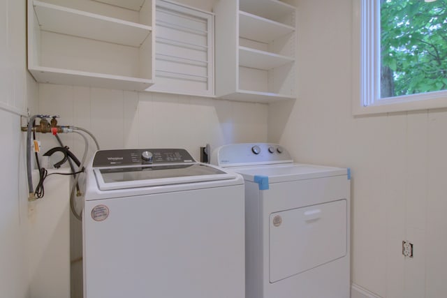 clothes washing area featuring washer and dryer