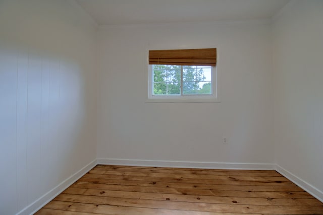 unfurnished room with ornamental molding and light hardwood / wood-style flooring