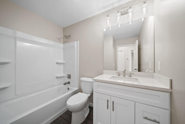 full bathroom featuring bathing tub / shower combination, hardwood / wood-style floors, vanity, and toilet