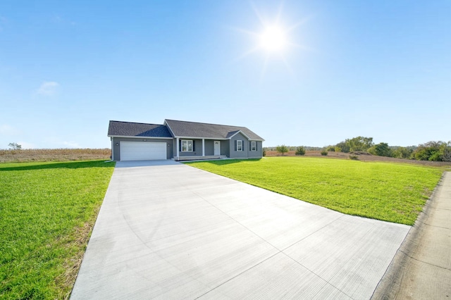 ranch-style house featuring a garage and a front lawn