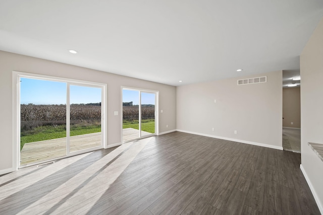 unfurnished living room with wood-type flooring