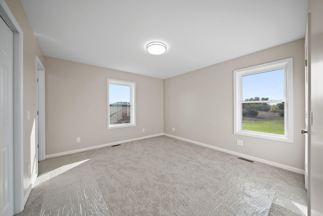 unfurnished bedroom with light carpet