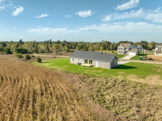 rear view of property featuring a lawn and a garage