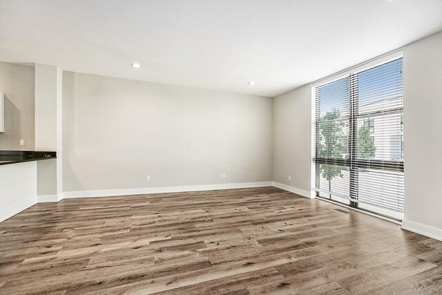 empty room with hardwood / wood-style floors