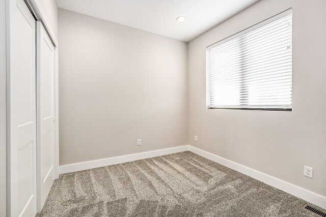 unfurnished bedroom with a closet and carpet