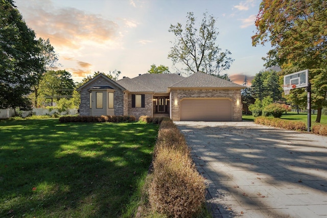 view of front facade featuring a lawn and a garage