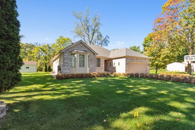 view of front of property with a front lawn and a garage