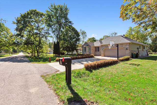 view of front of house featuring a front lawn and a garage