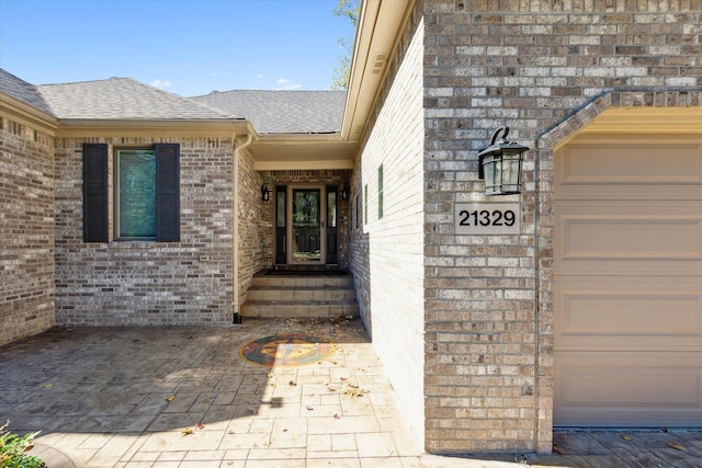 doorway to property featuring a garage