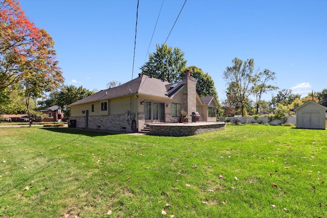 view of side of home featuring a lawn and a storage unit