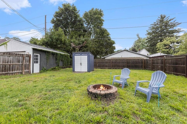 view of yard featuring a shed and an outdoor fire pit