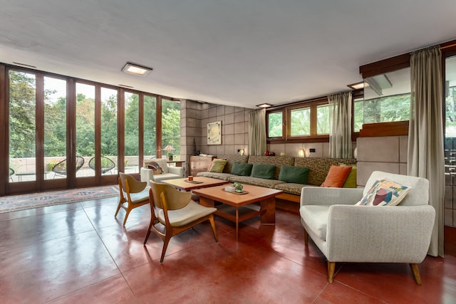 living room featuring concrete flooring and floor to ceiling windows