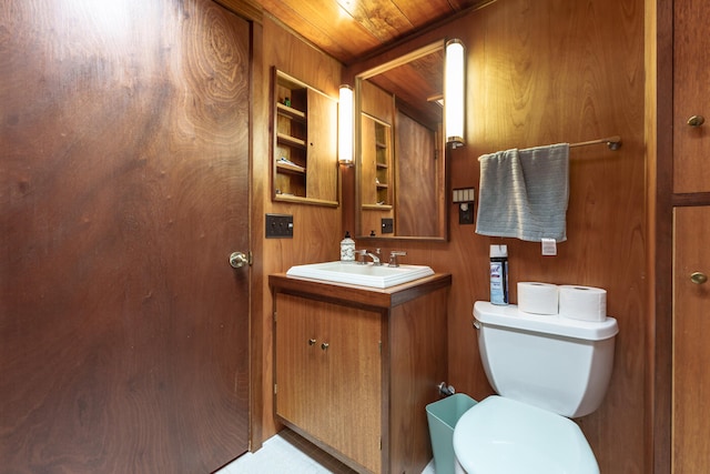 bathroom featuring vanity, wood walls, toilet, and wood ceiling