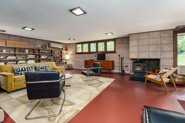 living room featuring a wall mounted AC, concrete floors, a wealth of natural light, and tile walls