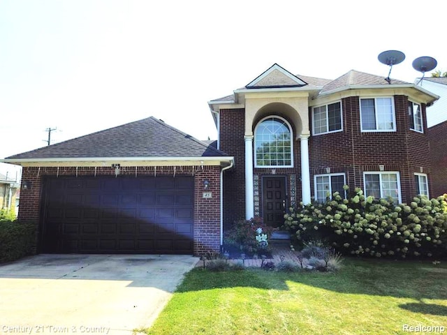 view of front of house featuring a garage and a front yard