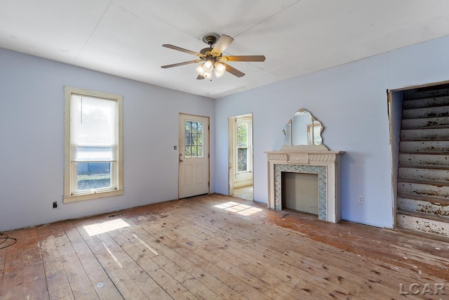 unfurnished living room with ceiling fan and light wood-type flooring