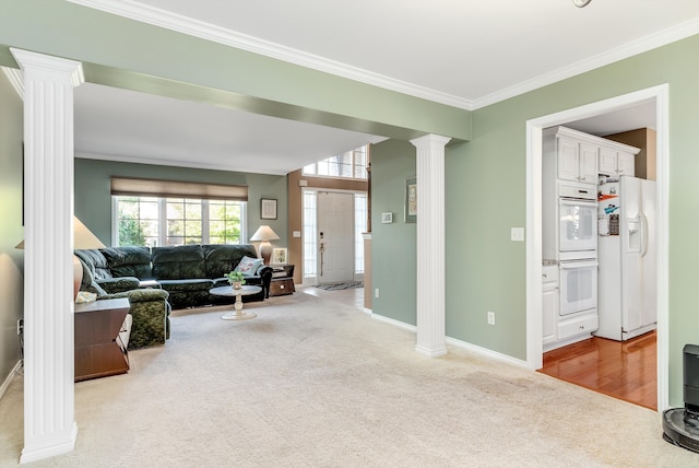 living room with light carpet, ornate columns, and ornamental molding