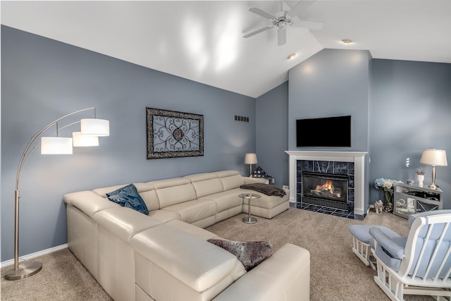 carpeted living room with ceiling fan, a premium fireplace, and vaulted ceiling