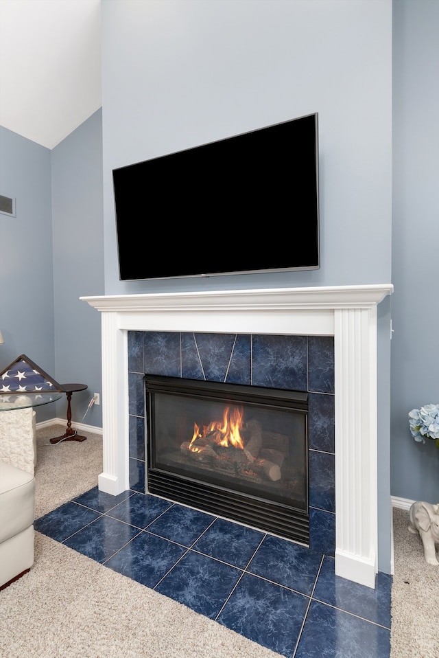 room details with carpet floors and a tiled fireplace