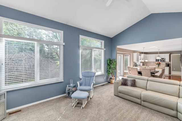 living room featuring ceiling fan, carpet, and high vaulted ceiling