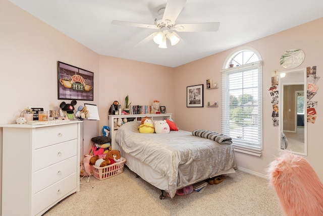 carpeted bedroom featuring ceiling fan and multiple windows