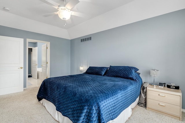 carpeted bedroom with ceiling fan, lofted ceiling, and ensuite bathroom