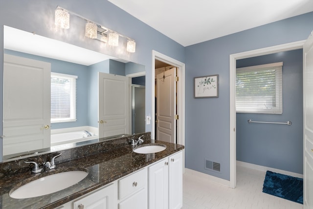 bathroom with shower with separate bathtub, vanity, and tile patterned floors