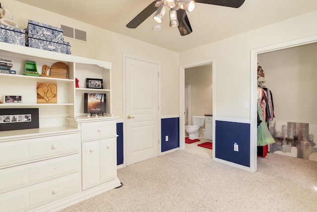 bedroom featuring ceiling fan and ensuite bathroom