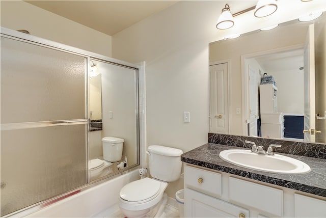 full bathroom with shower / bath combination with glass door, vanity, and toilet