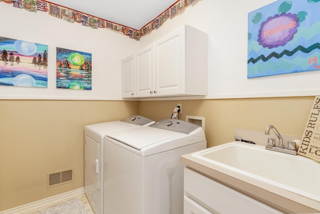 washroom featuring sink, light tile patterned floors, cabinets, and independent washer and dryer