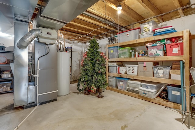 storage room featuring heating unit and water heater