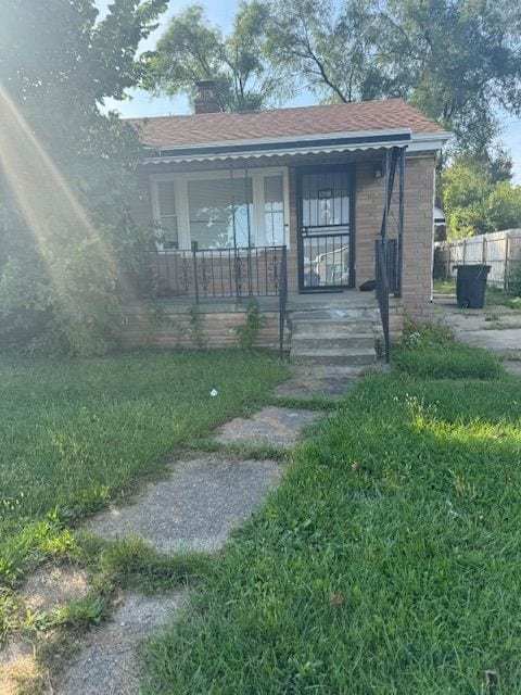 16813 Tireman St, Detroit, MI 48228 - view of front facade featuring a porch and a chimney
