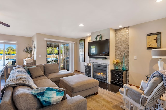 22461 Milner St, Saint Clair Shores, MI 48081 - living area with recessed lighting, baseboards, light wood finished floors, ceiling fan, and a glass covered fireplace