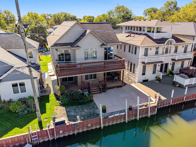 22461 Milner St, Saint Clair Shores, MI 48081 - rear view of house with a deck with water view, a residential view, a patio area, and a yard