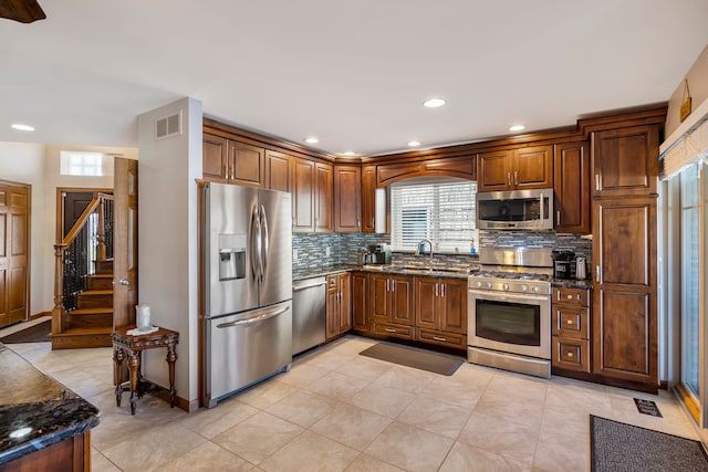 22461 Milner St, Saint Clair Shores, MI 48081 - kitchen with a sink, appliances with stainless steel finishes, decorative backsplash, recessed lighting, and dark stone counters