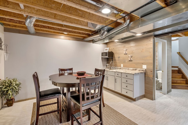 22461 Milner St, Saint Clair Shores, MI 48081 - dining area with light wood-style flooring, wood walls, baseboards, and stairs