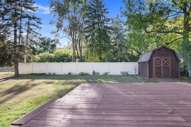 deck featuring a storage shed and a yard