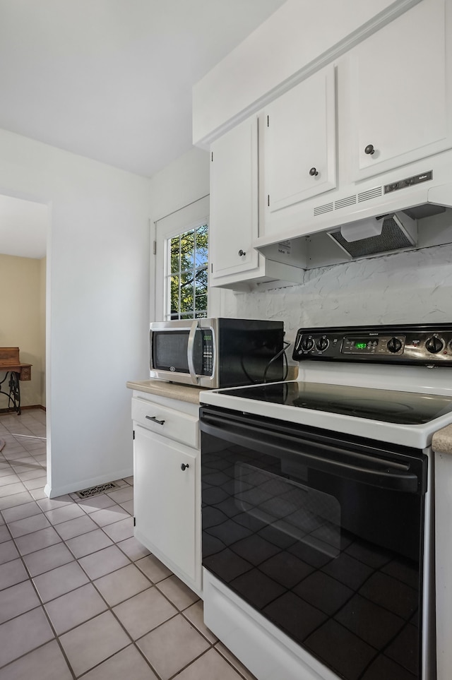 kitchen with white cabinets, decorative backsplash, white range with electric cooktop, and light tile patterned flooring