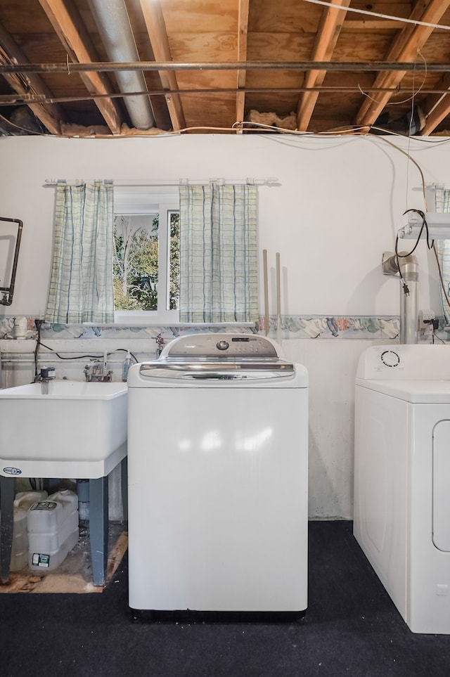 laundry room featuring washing machine and dryer and sink