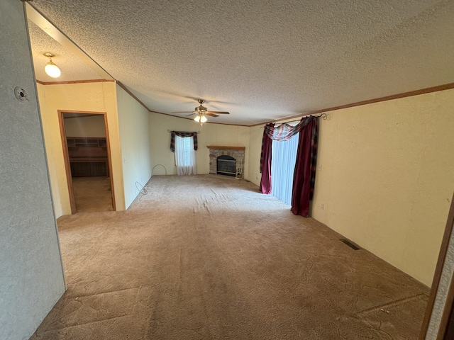 unfurnished living room with ceiling fan, crown molding, carpet floors, and a textured ceiling