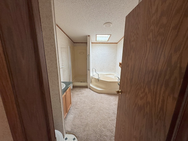 bathroom featuring vanity, crown molding, a skylight, separate shower and tub, and a textured ceiling