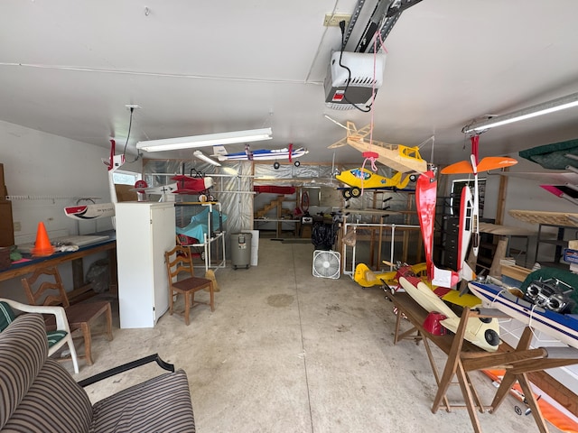 garage with a workshop area and a garage door opener