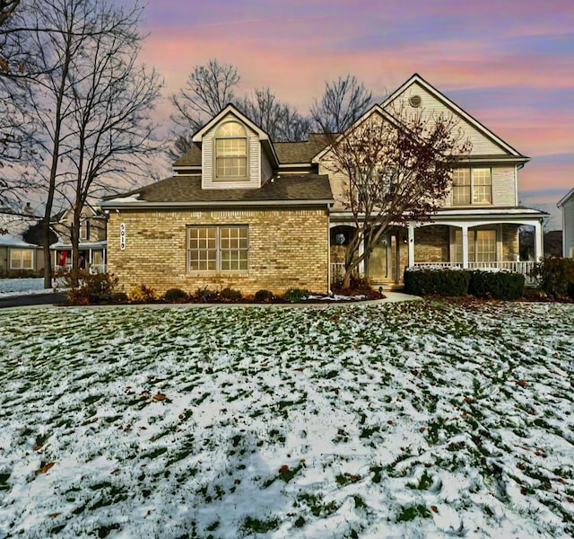 view of front of property featuring a yard and covered porch