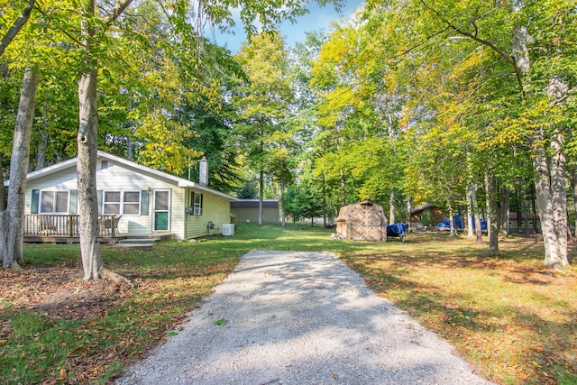 exterior space featuring a front lawn and a storage shed