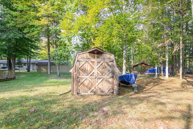 view of outbuilding with a yard