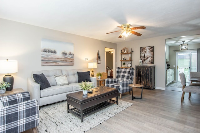 living room featuring ceiling fan and wood-type flooring