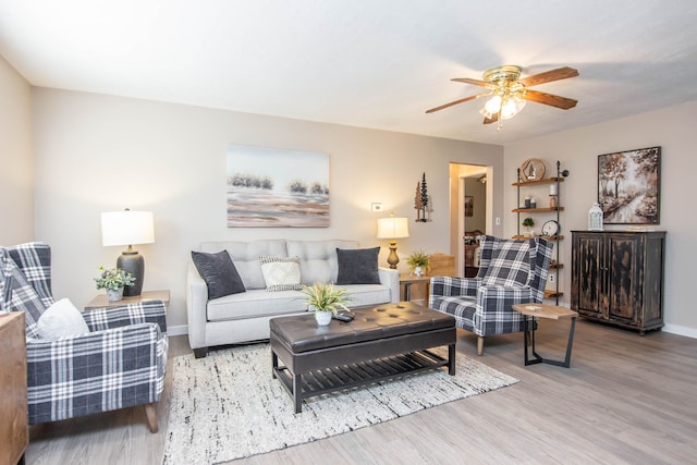 living room with ceiling fan and light wood-type flooring