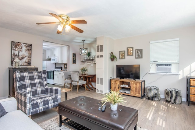 living room with light hardwood / wood-style flooring, ceiling fan, and cooling unit