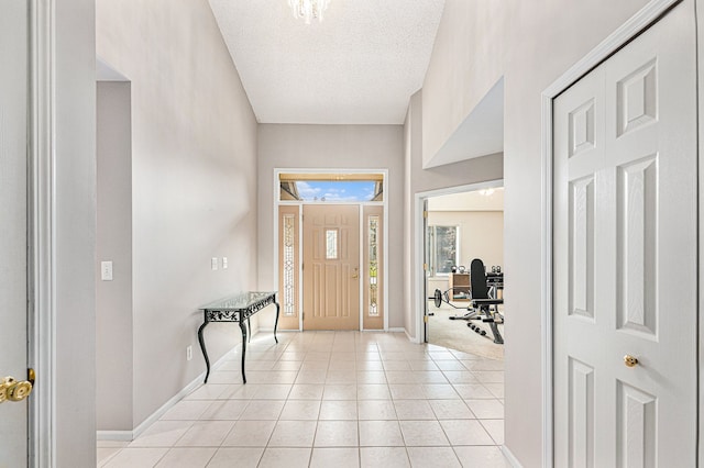 tiled foyer entrance featuring a textured ceiling